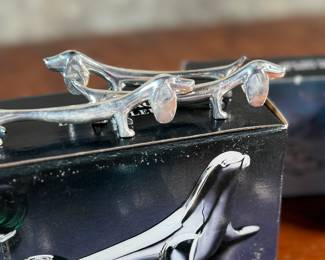 Proceeds from this lot will be donated to non-profit Salem Dogs in Marion County, Oregon. This lot features a set of twelve (12) dachshund fork holders & a silver plated seal bottle opener. All items come in their original packaging. Salem Dogs focus is on helping special needs dogs when their people experience extreme circumstances. Owner death, hospice, and nursing/assisted living situations are some examples that trigger the need for a new home. In addition, some people find themselves unable to afford medical bills and opt to have their dog euthanized. In those cases, Salem Dogs is often contacted and has either taken in the dog or helped the owner financially. While most of their work is in the Salem, Oregon area, this charity has helped dogs in multiple areas around North America.
