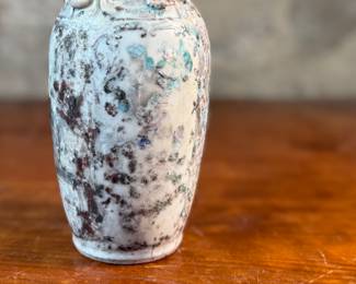 This lot features an antique Chinese sandy glazed vase that measures, 10” H x 4” W x 4” D.
