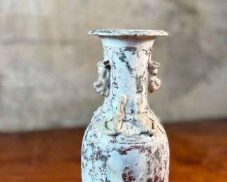 This lot features an antique Chinese sandy glazed vase that measures, 10” H x 4” W x 4” D.
