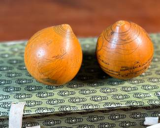 This lot features a pair of Chinese Lanzhou etched gourds displayed in a box. This type of gourd carving is a traditional folk art unique to Lanzhou, China, where carvers use fine tools to engrave landscapes, figures, and calligraphy onto the surface of the gourds. 
