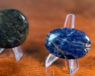 This lot features a collection of palm stones in excellent condition. The sodalite weighs 2.3oz and measures 3”, the labradorite weighs 5oz and measures 3”, and the pair of black opalite palm stones weigh 2.2oz each and measure, 2.5”.

