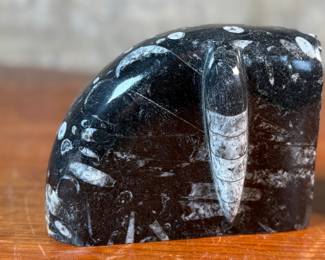 This lot features a pair of polished black marble Orthoceras fossil bookends. Each one measures, 4.5” H x 6” W x 3” D.
