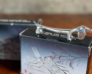 Proceeds from this lot will be donated to non-profit Salem Dogs in Marion County, Oregon. This lot features a set of twelve (12) dachshund fork holders & a silver plated seal bottle opener. All items come in their original packaging. Salem Dogs focus is on helping special needs dogs when their people experience extreme circumstances. Owner death, hospice, and nursing/assisted living situations are some examples that trigger the need for a new home. In addition, some people find themselves unable to afford medical bills and opt to have their dog euthanized. In those cases, Salem Dogs is often contacted and has either taken in the dog or helped the owner financially. While most of their work is in the Salem, Oregon area, this charity has helped dogs in multiple areas around North America.
