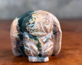 This lot features a hand-carved Inuit stone sculpture that measures, 4” H x 4” W x 2” D.
