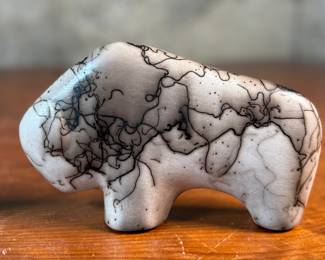 This lot features a pair of beautiful Native American Navajo horse hair pottery buffalo sculptures. Both are signed by artists as shown in photos and each measures, 4” H x 6.5” W x 1.25” D.
