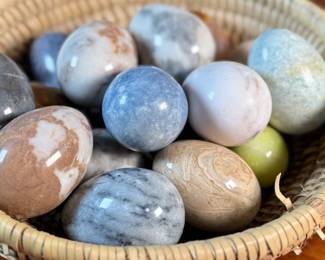 This lot features a collection of fifteen (15) polished stone eggs made from various materials in excellent condition and a fun basket to carry them to your car in!
