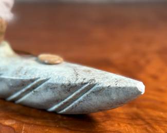 This lot features a hand-carved soapstone sculpture of an Inuit hunter and kayak. Signed underneath and measures, 6” H x 15” W x 3” D. The hunter has come detached as shown in photos and can sit just fine or be reattached.
