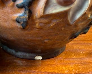 This lot features a collection of seven (7) Roseville Pottery items in the "Magnolia" pattern, which was introduced in 1943. The set includes a large cider pitcher and several matching mugs, featuring pink and white blossoms on a textured russet and green ground. All items are in excellent condition with one piece showing a very small chip as shown in photos. The pitcher measures, 8.5” H.
