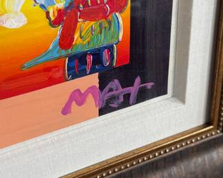 “Umbrella Man”, an over-painted serigraph by listed artist, Peter Max. Signed lower right and professionally framed by Park West Gallery. Measures in frame, 27.75” H x 25.75” W. Peter Max is a German-American artist known for using bright colors in his work. Works by Max are associated with the visual arts and culture of the 1960s, particularly psychedelic art and pop art.
