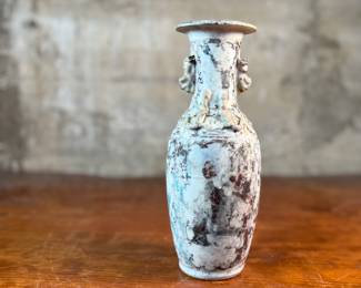 This lot features an antique Chinese sandy glazed vase that measures, 10” H x 4” W x 4” D.
