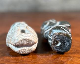 This lot features a pair of Chinese Hongshan Culture hand-carved amulet sculptures, sometimes described as "Sun God Helios" statutes. Each one measures, 5.5” H.
