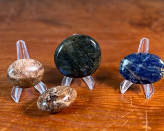 This lot features a collection of palm stones in excellent condition. The sodalite weighs 2.3oz and measures 3”, the labradorite weighs 5oz and measures 3”, and the pair of black opalite palm stones weigh 2.2oz each and measure, 2.5”.
