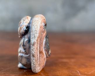 This lot features a hand-carved Inuit stone sculpture that measures, 4” H x 4” W x 2” D.
