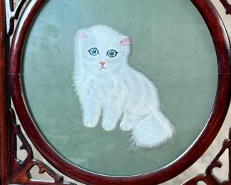 This lot features a vintage Chinese double-sided silk embroidery table screen featuring a a cat on each side, housed in a carved wooden display stand. This piece measures, 17” H x 13” W x 5” D.
