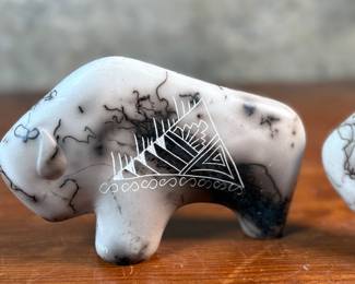 This lot features a pair of beautiful Native American Navajo horse hair pottery buffalo sculptures. Both are signed by artists as shown in photos and each measures, 4” H x 6.5” W x 1.25” D.
