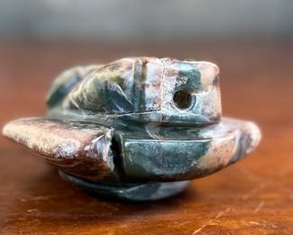 This lot features a hand-carved Inuit stone sculpture that measures, 4” H x 4” W x 2” D.
