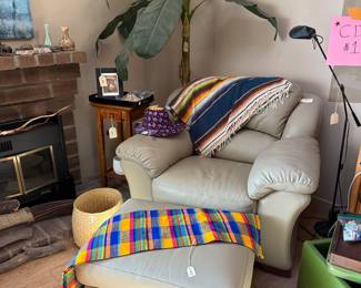 Ivory Chair and Ottoman, Beautiful Woven Blankets, Plant, Lamps.