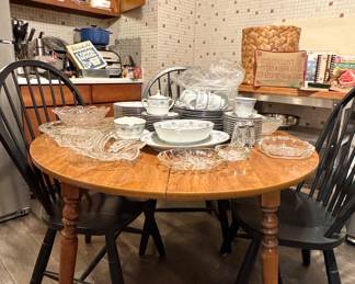 Estate Sale Kitchen Table Setup with Vintage China and Glass Serving Dishes