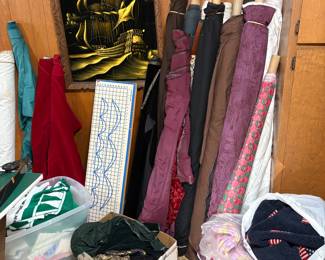 Bolts of Fabric including velvet. Pieces of fabric in bins.