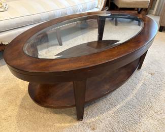 Oval wood coffee table with glass insert