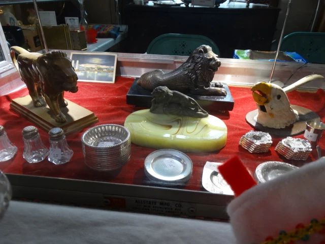 Collectibles Case w/ Small Silver , Onyx Ashtray w/ Lion Figure, Heavy Bronze Standing Lion Nut Cracher and a Metal Eagle Nutcraccker