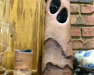 Native American pottery set with candle that illuminates the faces inside the larger piece