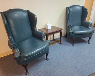Blue leather wingback chair with side table