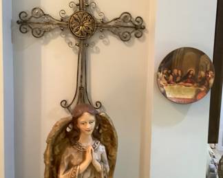 The cross above the Angel and a plate of the last supper.