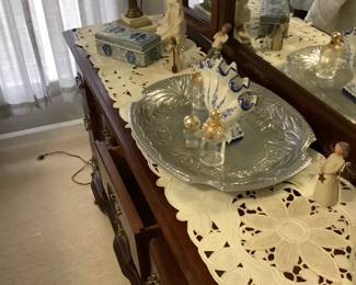 Mahogany dresser in bedroom. It measures: 64”; length, 18” depth. Has 9 drawers. 3 way mirror measures: 54” wide x 51 1/2” tall. Price is: $395.00.