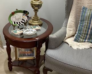 Wing back, blue and white stripe chair. Sitting by one of the two end tables. Measures: 27 1/2” length, 21 3/4” width, 24” height. Price is 95.00 each.