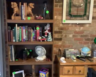 One of the many bookcases with books and great items in sunroom.