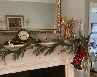 Mantle decorated out with stockings, garland, 2 gold Angels, crystal hurricanes and small Angels.