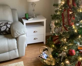 2 white end tables by leather sofa. Has 2 drawers. The end tables are: $70.00 each.