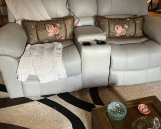 Close-up of leather remote control love seat. Both the love seat and sofa are new. Price for both are: $1,906.00.