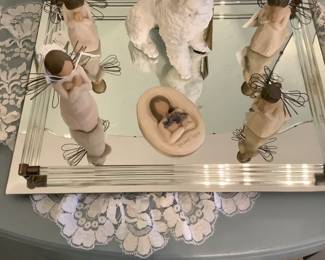 Glass tray with Willow Tree figurines on it.