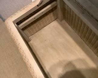 Inside of wicker trunk.