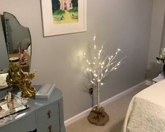 A Christmas tree that lights up in the master bedroom.