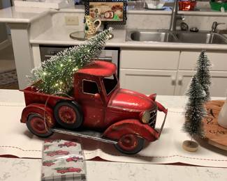Here comes the red Christmas truck with the lighted tree.