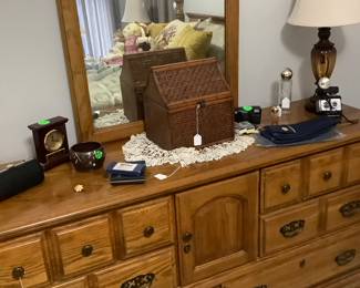 Oak dresser with mirror with 6 drawers, 2 in center with doors. It is by Broyhill. It measures: 66” width x 31 1/2” tall. The mirror measures: 47 1/2 tall, 28” wide.