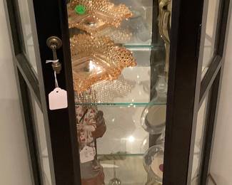 Just one of the lighted curio cabinets with glass shelves. Has some beautiful crystal, and carnival glass. Price is: $95.00.