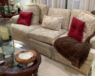 Beige tone on tone, 3 seater, couch in living room. No name on it, but believe it is a Broyhill. Has pleated bottom. It measures: 89” width, 37 1/2 depth, 17” from floor. Price: $365.00. Coffee table: Price: $160.00. Has bottom shelf and glass insert.