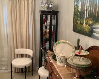 View with curio cabinets, chairs and walnut buffet.