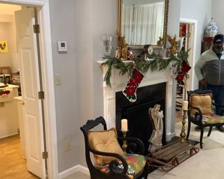 A large beveled mirror above decorated mantle with all the trimmings.