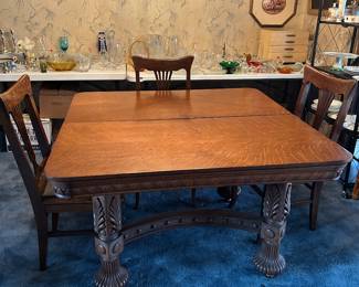 Fabulous oak dining room table.  Has 3 oak leaves for expansion.  Also pictured are 3 of the 7 oak dining chairs.