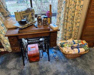 Sewing machine, antique sewing cabinet, fabrics and sewing items (threads, buttons, sewing box full of stuff).  The curtains also match a comforter set and are available.