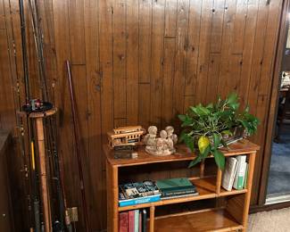 Rattan bookcase.   Fishing rods and reels.  Plant stands.