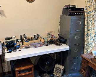 Electronics and file cabinet.  Phone set, speakers, etc.