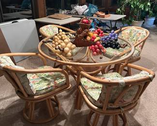 Rattan glass top dining table and 4 chairs.
