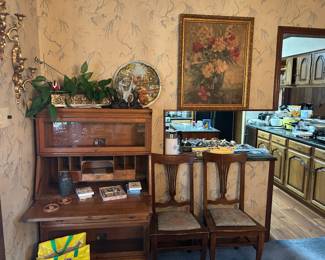 Antique oak secretary.  Also pictured are two of the 7 dining room oak chairs.