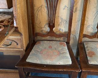 One of seven oak dining chairs.